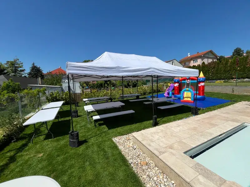 Menšie party stany pri bazéne s detským skákacím hradom